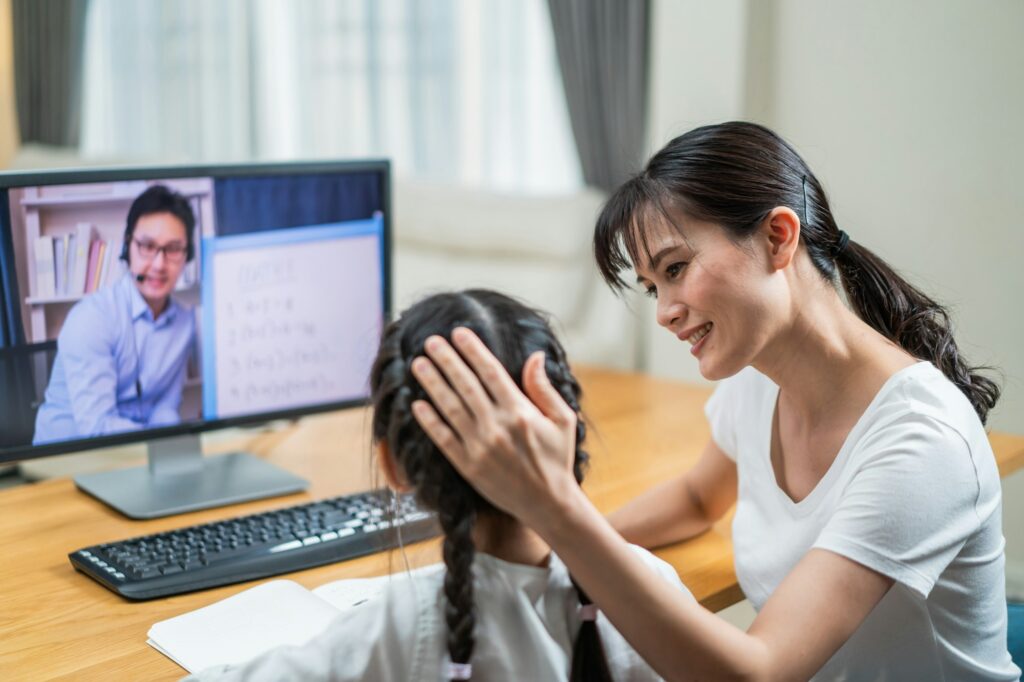 Asian little girl learning online class from teacher by digital remote internet due to coronavirus.